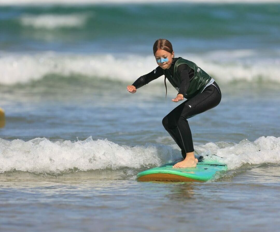 young girl surfing at lacanau